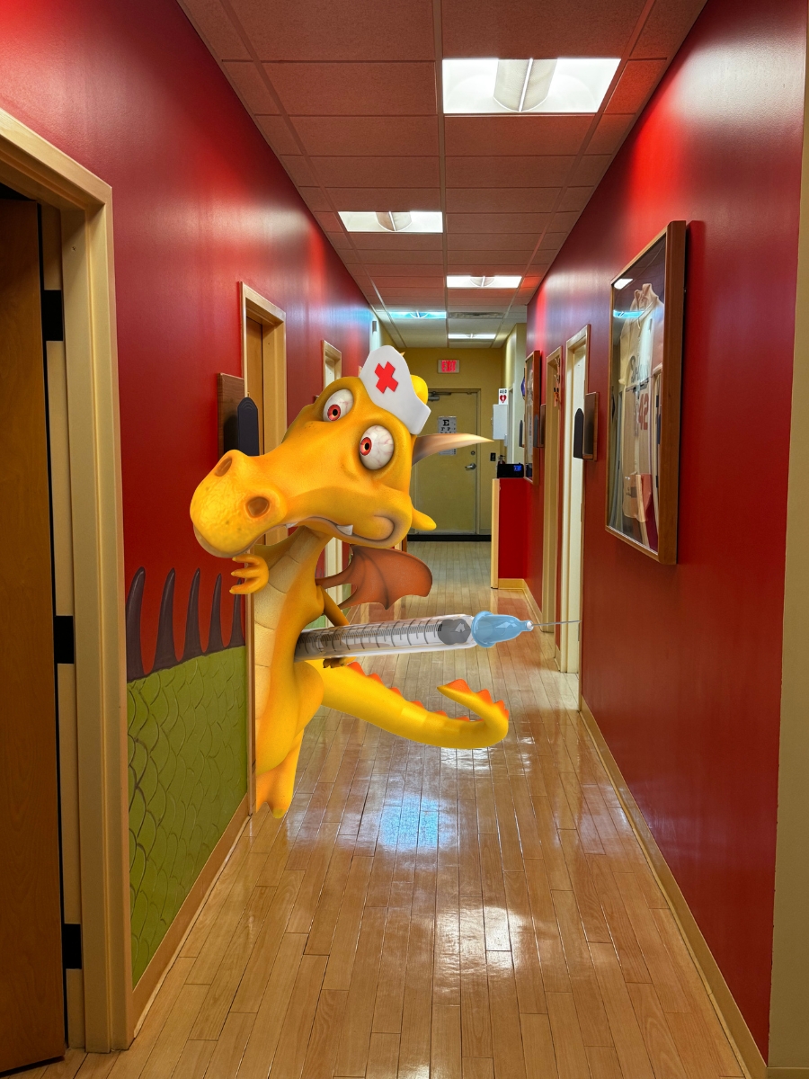 A cartoon dragon dressed as a nurse holds a large syringe while standing in a brightly lit hallway with red walls, ready to help at a pediatrician in Melbourne, FL.
